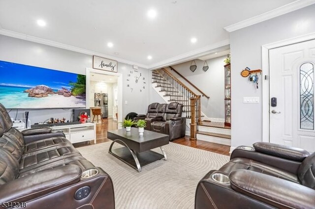 living area featuring recessed lighting, wood finished floors, stairs, and crown molding