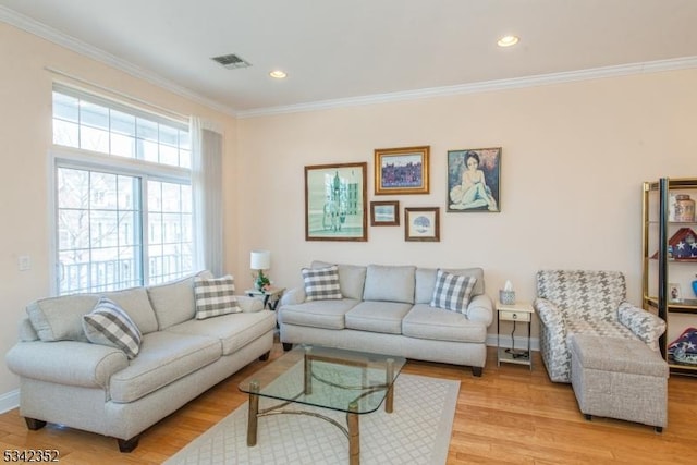 living area with recessed lighting, light wood-type flooring, baseboards, and ornamental molding