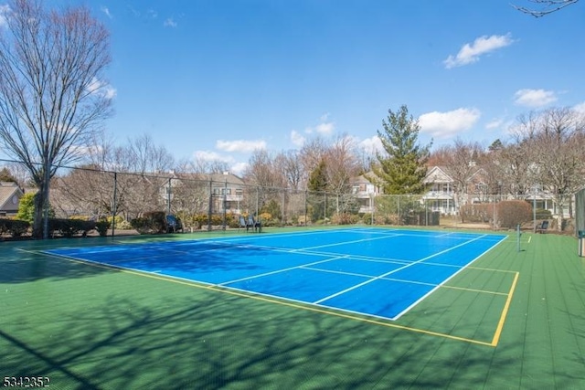 view of sport court featuring fence