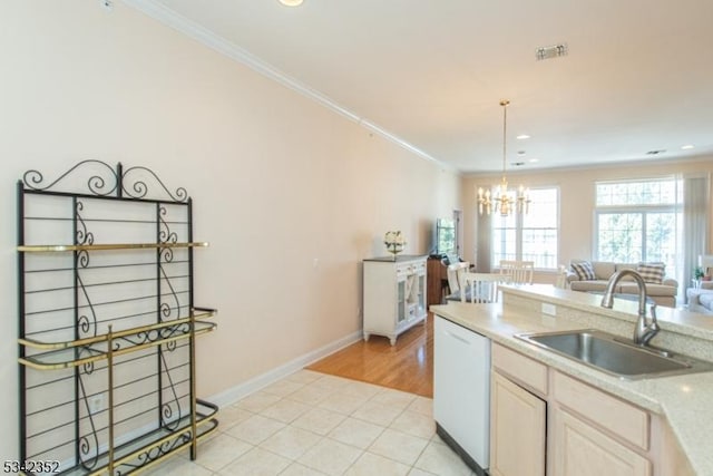 kitchen with crown molding, white dishwasher, a chandelier, and a sink