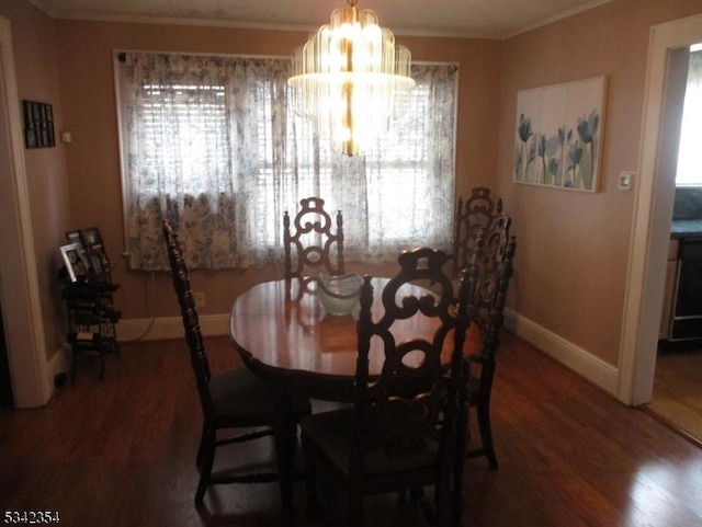 dining area featuring plenty of natural light, crown molding, baseboards, and wood finished floors