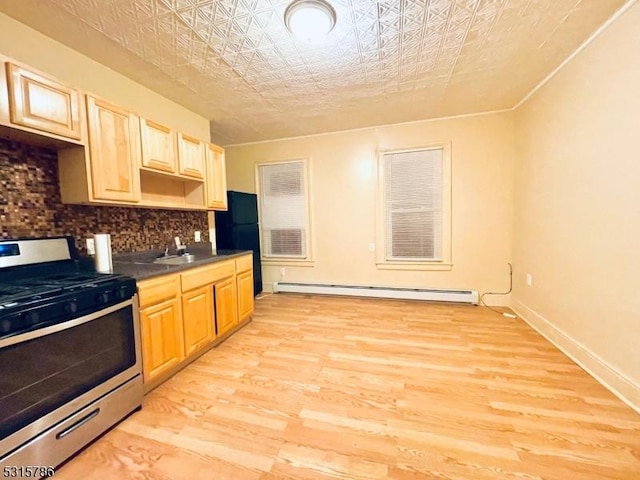 kitchen featuring an ornate ceiling, stainless steel range with gas stovetop, baseboard heating, light wood-type flooring, and backsplash