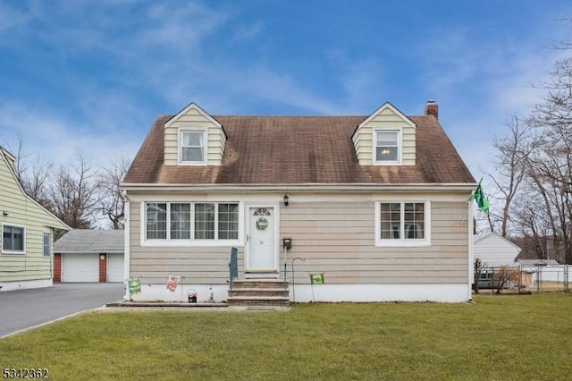 cape cod home with a front yard, an outbuilding, and entry steps