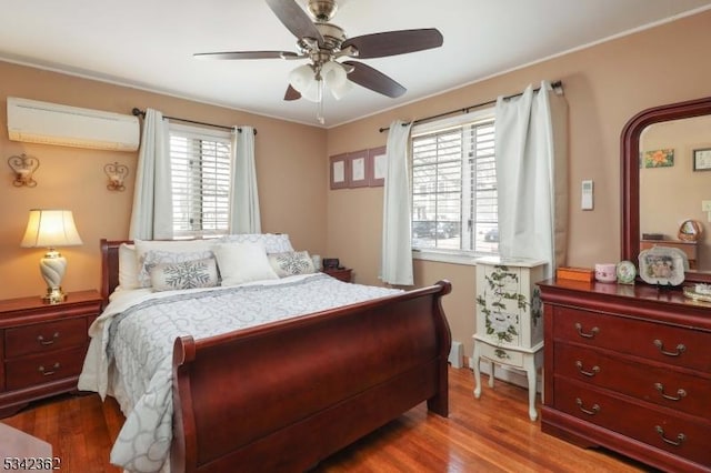 bedroom with a ceiling fan, dark wood-style flooring, and a wall mounted air conditioner