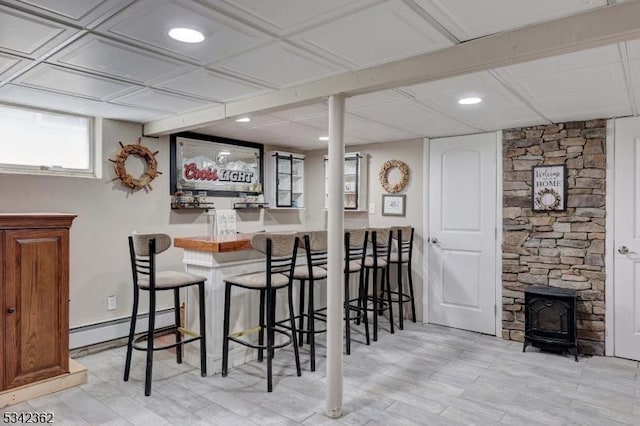 dining area with a dry bar, a baseboard radiator, and recessed lighting