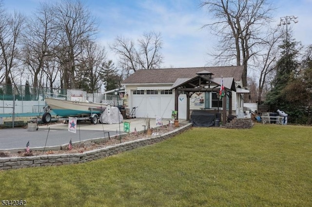 exterior space with a garage, driveway, fence, and a gazebo