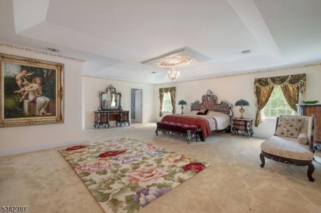 carpeted bedroom with a tray ceiling, visible vents, baseboards, and an inviting chandelier