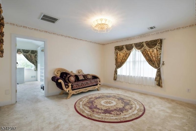 living area with carpet floors, a healthy amount of sunlight, and visible vents