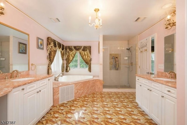 bathroom with visible vents, a sink, and a shower stall