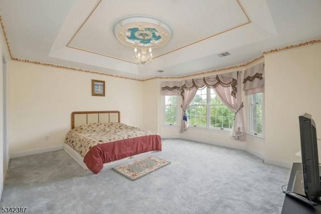 bedroom featuring carpet, a raised ceiling, visible vents, a chandelier, and baseboards