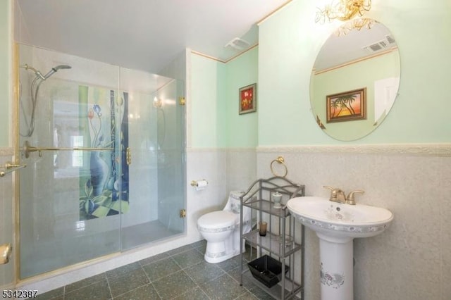 full bath featuring toilet, a stall shower, visible vents, and wainscoting