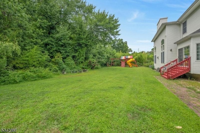 view of yard with entry steps and a playground