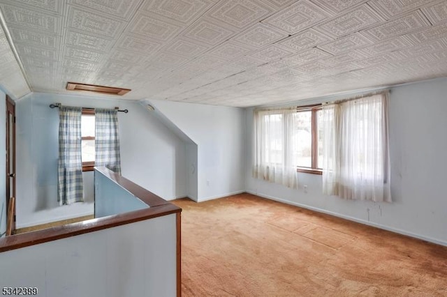 bonus room with carpet, plenty of natural light, and baseboards