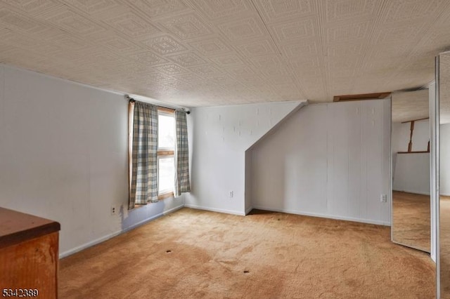 bonus room with carpet floors and baseboards