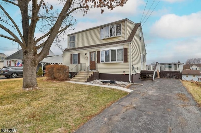 view of front facade with a deck and a front lawn