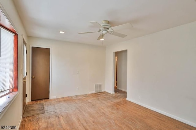 unfurnished room with recessed lighting, visible vents, light wood-style floors, a ceiling fan, and baseboards