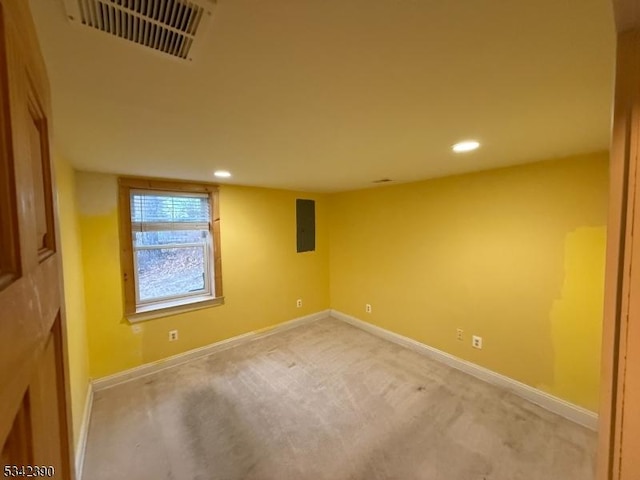 empty room with light colored carpet, visible vents, and baseboards