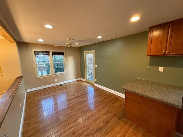 interior space with ceiling fan, baseboards, wood finished floors, and recessed lighting