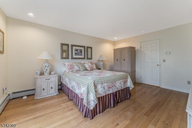 bedroom with a baseboard heating unit, recessed lighting, light wood-style flooring, and baseboards