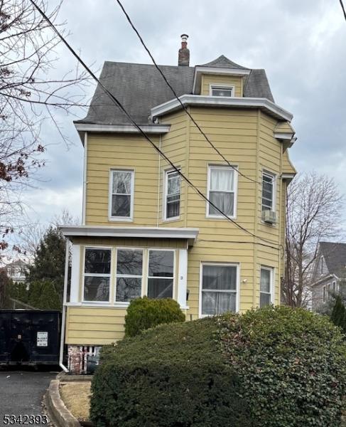 view of front facade featuring a chimney