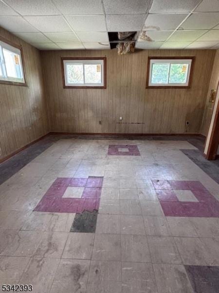 1 Reid Ave, Passaic City, NJ 07055 - spare room featuring tile patterned floors, plenty of natural light, and wood walls