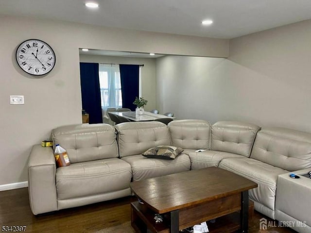 living room with baseboards, wood finished floors, and recessed lighting