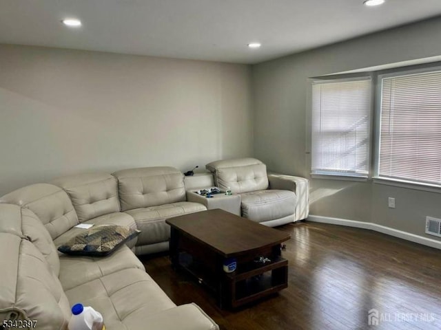 living area with visible vents, baseboards, wood finished floors, and recessed lighting