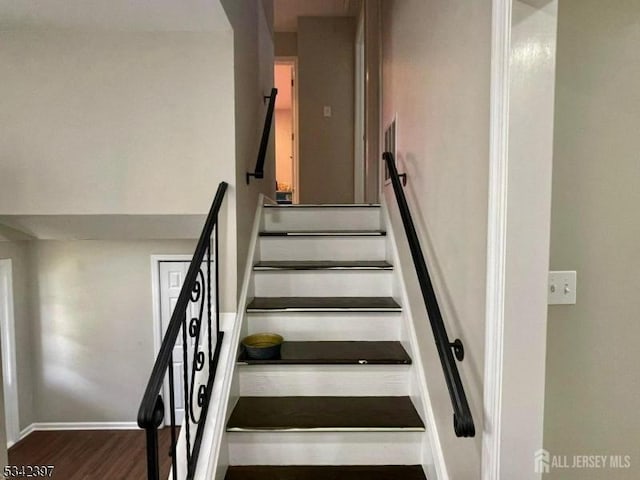 stairs with baseboards and wood finished floors