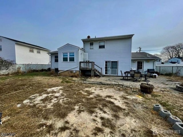 rear view of property with fence