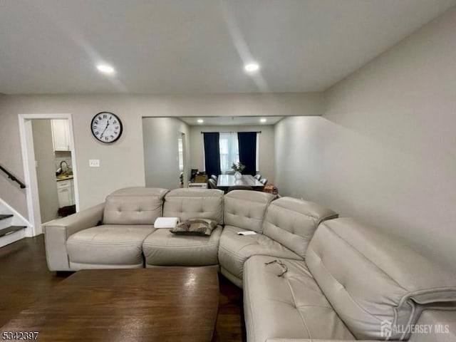 living area featuring stairway, dark wood finished floors, and recessed lighting