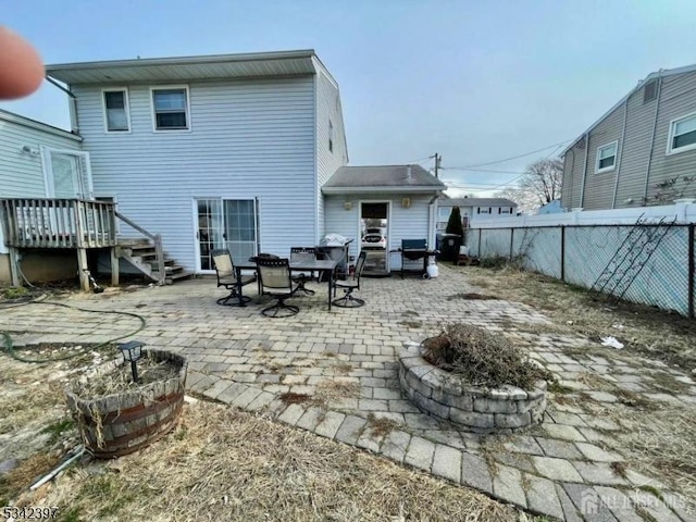 rear view of house featuring fence and a patio