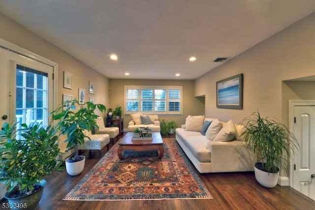 living room with wood finished floors, visible vents, and recessed lighting