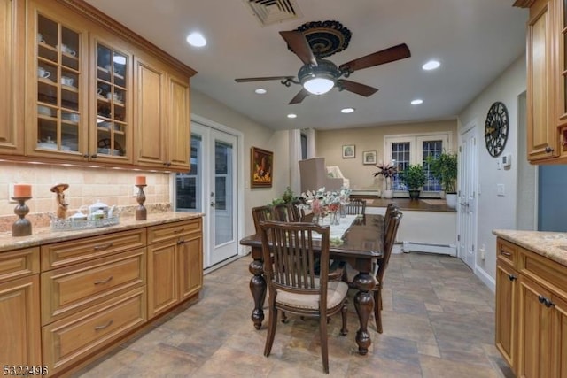 dining room with french doors, recessed lighting, visible vents, a baseboard heating unit, and stone finish flooring