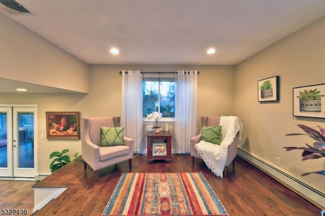 sitting room with a baseboard radiator, recessed lighting, wood finished floors, visible vents, and french doors