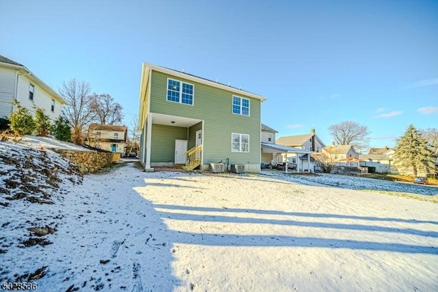 back of property with cooling unit and volleyball court