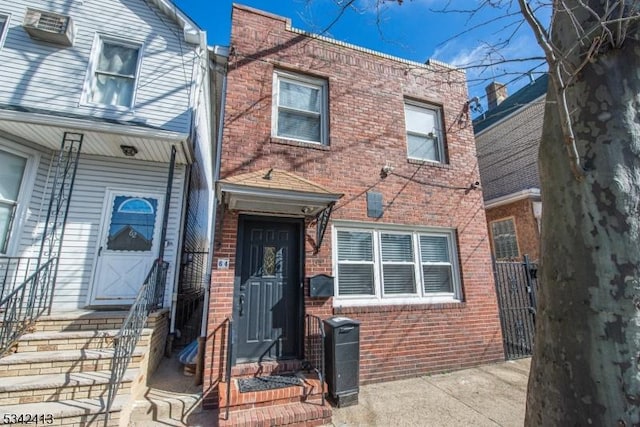 townhome / multi-family property with brick siding