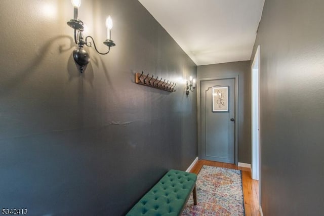 doorway to outside with light wood-style floors and baseboards