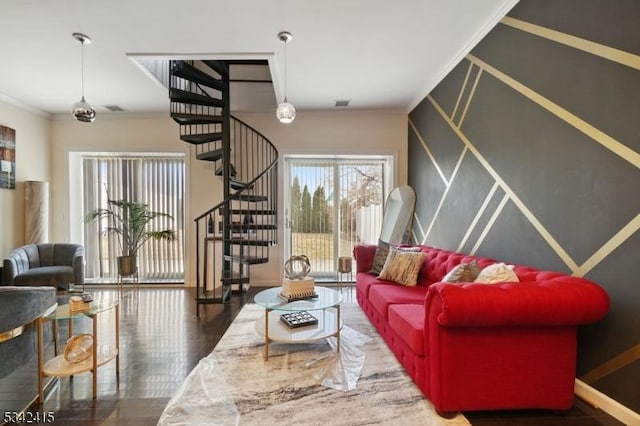 living room with stairway, wood finished floors, visible vents, and ornamental molding