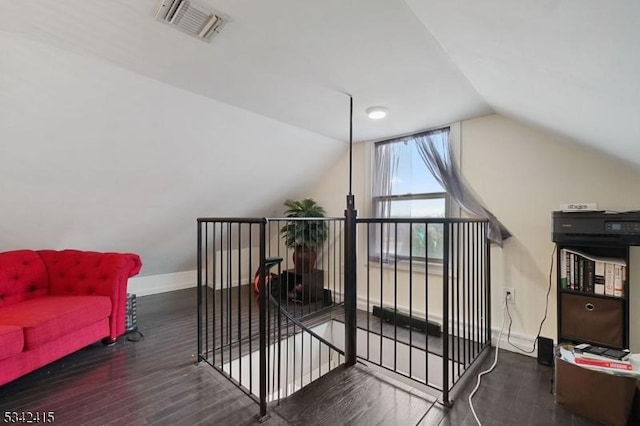 bonus room with vaulted ceiling, visible vents, baseboards, and wood finished floors