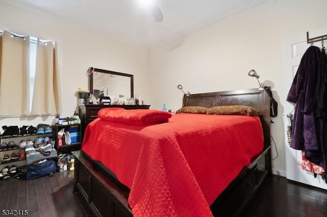 bedroom featuring wood finished floors, a ceiling fan, and ornamental molding