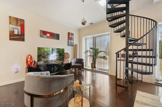 living area featuring stairway, baseboards, visible vents, and wood finished floors