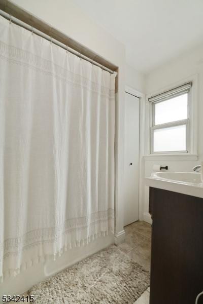 bathroom with tile patterned floors and vanity