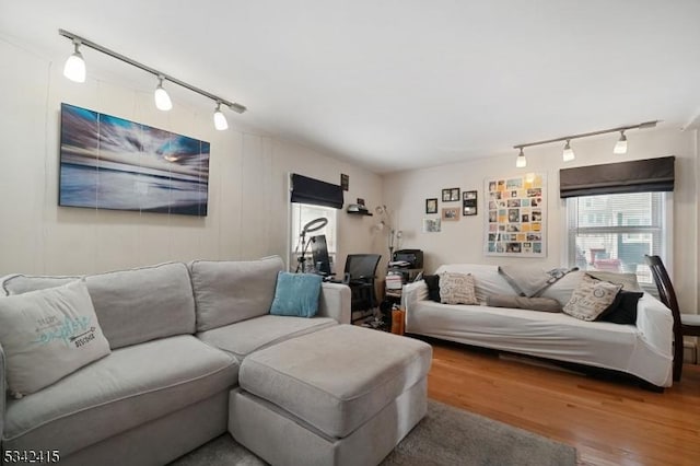 living area featuring wood finished floors and rail lighting