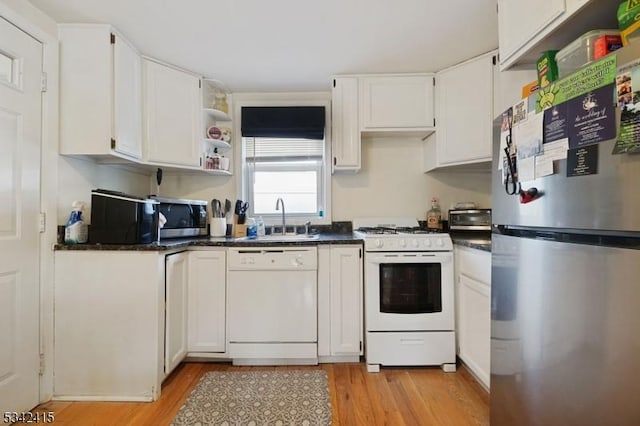 kitchen with light wood-style flooring, a sink, open shelves, white cabinetry, and appliances with stainless steel finishes