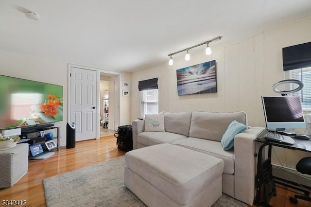 living room featuring wood finished floors and track lighting