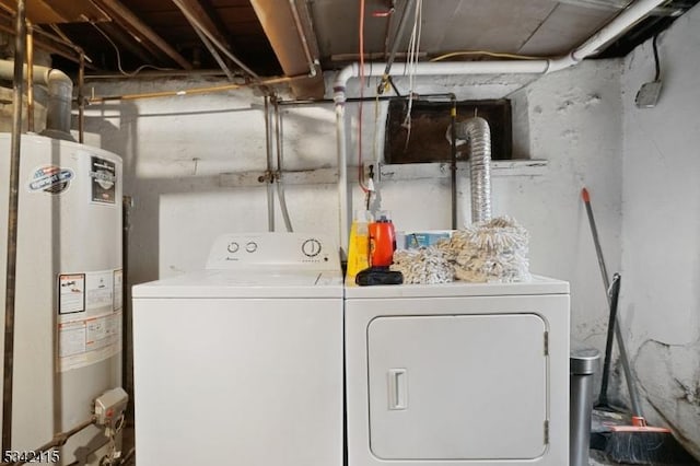 laundry area with water heater, laundry area, and washing machine and dryer