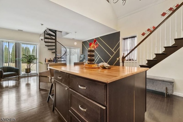 bar featuring vaulted ceiling, stairway, baseboards, and dark wood-style flooring