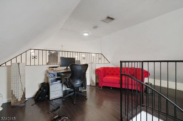 office space featuring hardwood / wood-style flooring, baseboards, visible vents, and vaulted ceiling