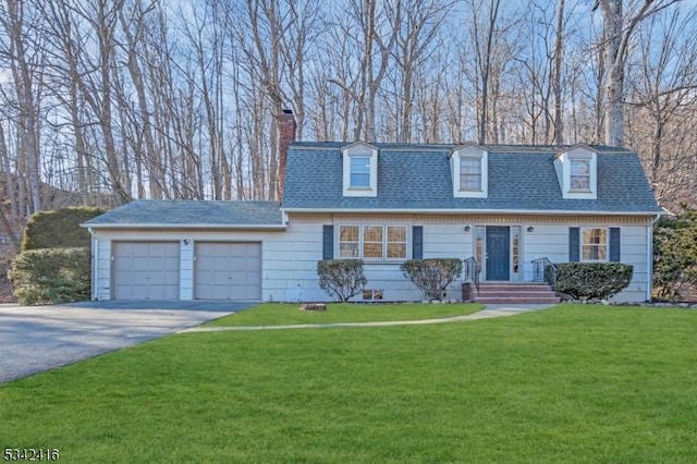 view of front of property with a garage, driveway, a shingled roof, a chimney, and a front yard