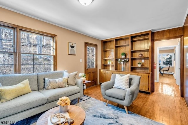 living room featuring ornamental molding and light wood-type flooring